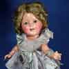 Shirley Temple 1930s composition doll wearing Curly Top starburst outfit