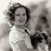 Shirley Temple at home with her dog Ching Ching, September 1937