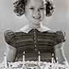 Shirley Temple and birthday cake, April 1938