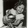 Shirley Temple with watering can, 1935