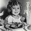 Shirley Temple eating lunch during filming of The Little Colonel, 1935