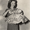 Shirley Temple holding dress from Stand Up And Cheer, 1944